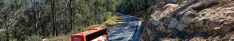 NSW TrainLink coach driving on rural road